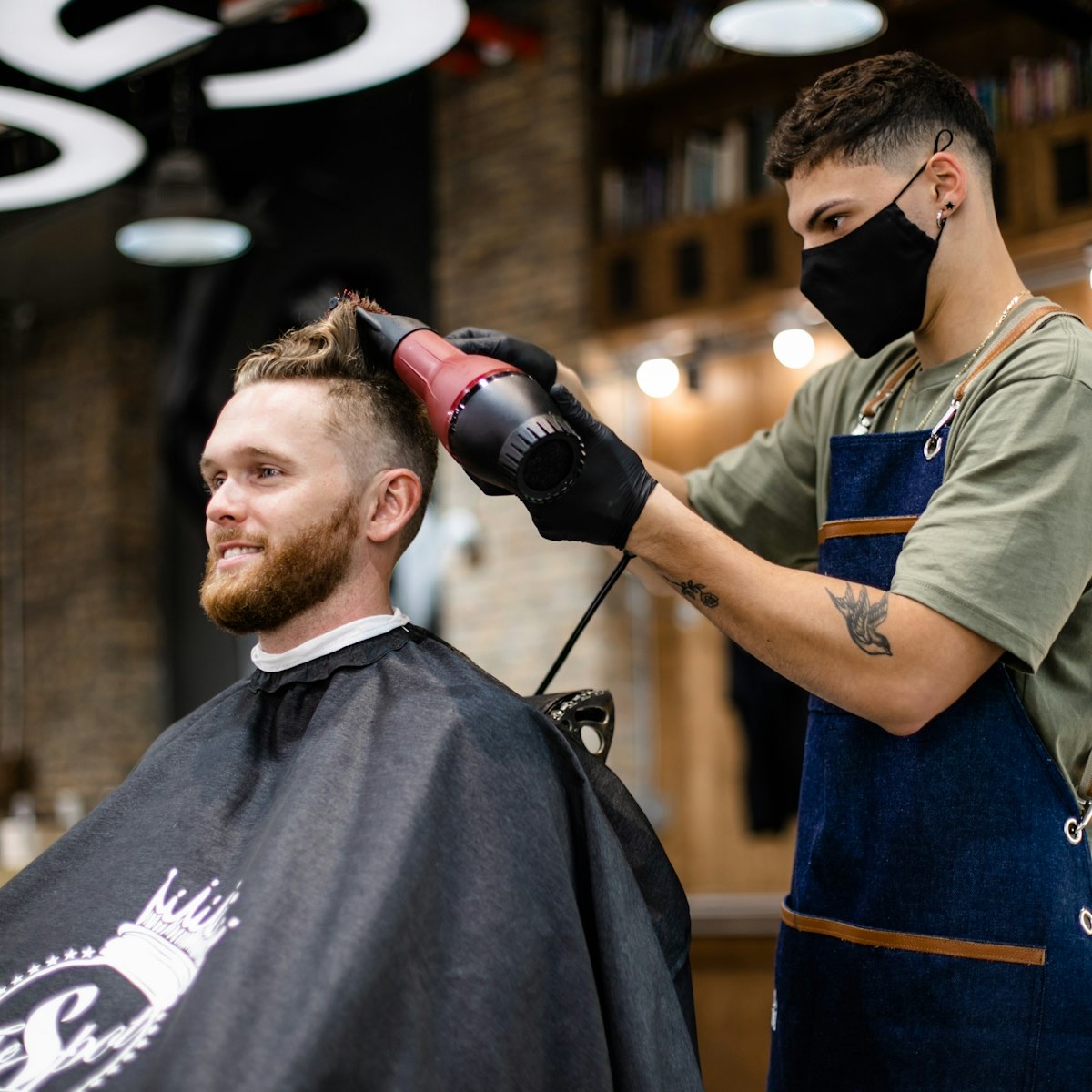 Close-up of curly hair being cut dry